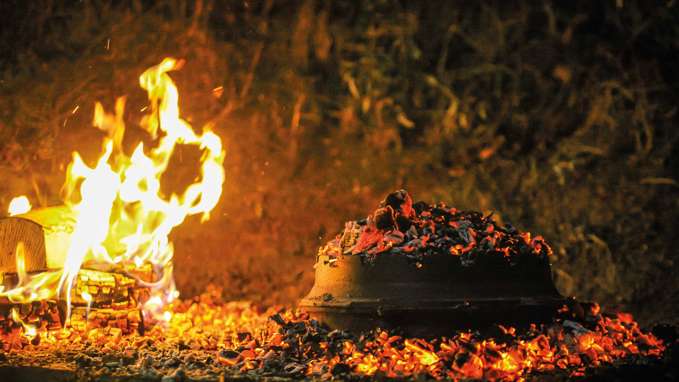 Food cooking over an open fire and charcoals